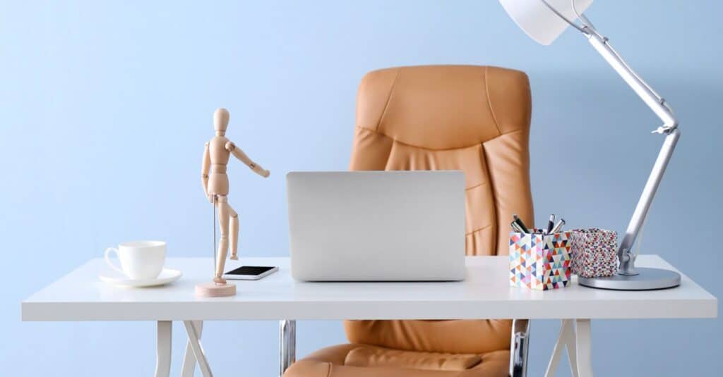 best home office chairs for back pain - Modern workplace with office chair and laptop